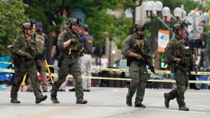 Law enforcement search after a mass shooting at the Highland Park Fourth of July parade in downtown Highland Park, Ill., a suburb of Chicago, July 4, 2022. (AP Photo/Nam Y. Huh)
