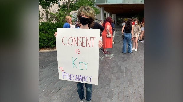 A participant at the rally holds a sign. (CTV Kitchener)