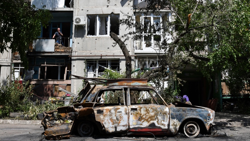 A destroyed car lies next to an apartment building damaged by an overnight missile strike in Sloviansk, Ukraine, May 31, 2022. (AP Photo/Andriy Andriyenko)