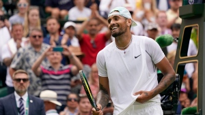 Australia's Nick Kyrgios celebrates after beating Brandon Nakashima of the US in a men's singles fourth round match on day eight of the Wimbledon tennis championships in London, Monday, July 4, 2022. (AP Photo/Alberto Pezzali)