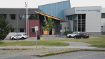 Police vehicles are seen outside a Surrey high school after a stabbing on Monday, July 4, 2022. 