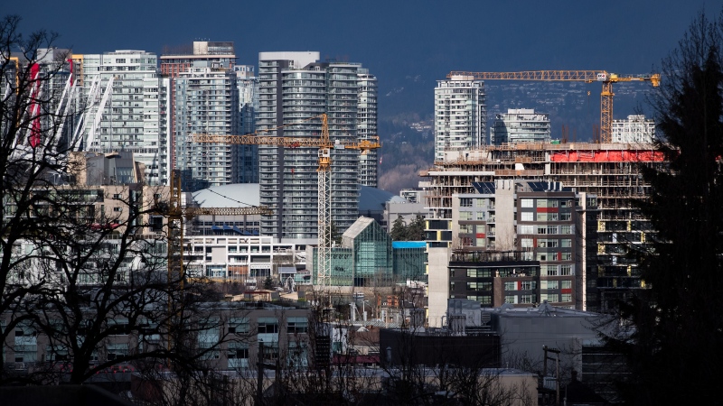Cranes tower above condos under construction near southeast False Creek in Vancouver, on Sunday Feb. 9, 2020.  THE CANADIAN PRESS/Darryl Dyck 