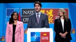 Canada's Prime Minister Justin Trudeau, center, speaks during a media conference at a NATO summit in Madrid, Spain on Thursday, June 30, 2022. (AP Photo/Manu Fernandez)