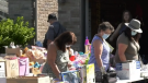 People browse merchandise at a garage sale in Innisfil, Ont. on July 10, 2021. (Steve Mansbridge/CTV News Barrie)