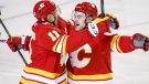 Calgary Flames forward Andrew Mangiapane, right, celebrates his goal with teammate forward Mikael Backlund during first period NHL second round playoff hockey action against the Edmonton Oilers in Calgary on May 18, 2022. (THE CANADIAN PRESS/Jeff McIntosh)