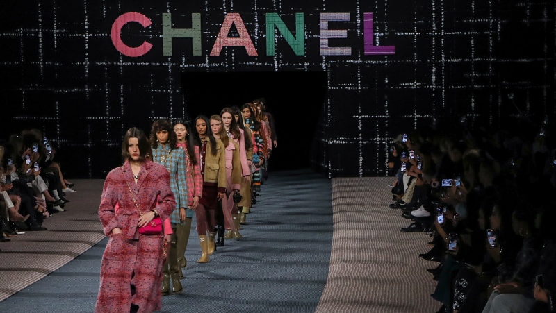 Models wear creations as part of the Chanel Ready To Wear Fall/Winter 2022-2023 fashion collection, unveiled during the Fashion Week in Paris, Tuesday, March 8, 2022. (Photo by Vianney Le Caer/Invision/AP)