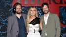 Millie Bobby Brown, centre, poses with executive producer/directors Matt Duffer, left, and Ross Duffer at the premiere of "Stranger Things" season four at Netflix Studios Brooklyn, May 14, 2022, in New York. (Photo by Evan Agostini/Invision/AP)