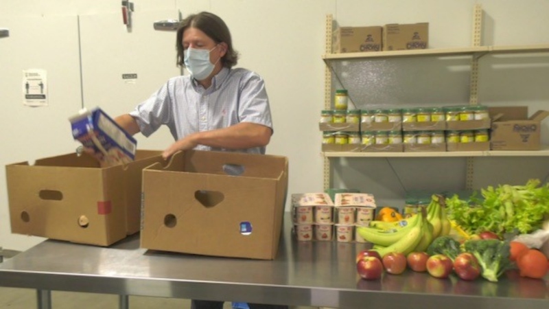Andy Mills packs up a box for The Food Sharing Project’s summer food delivery program. (Kimberley Johnson/CTV News Ottawa)