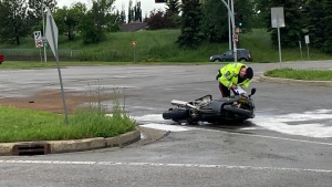 Police are investigating a crash between a motorcycle and a vehicle in south Edmonton on Tuesday, July 5, 2022. (Brandon Lynch/CTV News Edmonton)