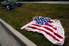 Empty chairs and an American flag blanket lie on the ground after a mass shooting at the Highland Park Fourth of July parade in downtown Highland Park, a Chicago suburb on Monday, July 4, 2022. (AP Photo/Nam Y. Huh)