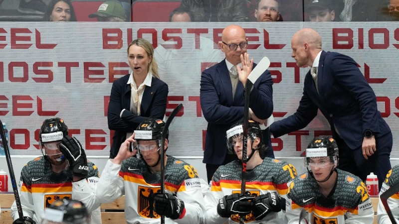 Germany's assistant coaches Jessica Campbell, Tom Rowe and head coach Toni Soderholm, from left, react on the bench during the Hockey World Championship quarterfinal match between Germany and the Czech Republic in Helsinki, Finland, May 26, 2022. (AP Photo/Martin Meissner, File)