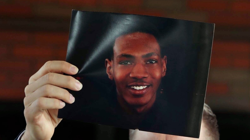 Attorney Bobby DiCello, representing the family of Jayland Walker, holds up a photograph of Walker before he and his legal team give their statements after the City of Akron's news conference at the Firestone Park Community Center on Sunday, July 3, 2022, in Akron, Ohio. (Karen Schiely/Akron Beacon Journal via AP)