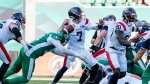 Saskatchewan Roughriders defensive lineman Anthony Lanier II (91) forces Montreal Alouettes quarterback Trevor Harris (7) to fumble the football during first half CFL football action in Regina, on Saturday, July 2, 2022. THE CANADIAN PRESS/Heywood Yu.