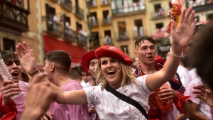 Revelers celebrate while waiting for the launch of the 'Chupinazo' rocket, to mark the official opening of the 2022 San Fermin fiestas in Pamplona, Spain, Wednesday, July 6, 2022. (AP Photo/Alvaro Barrientos)