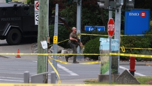 Saanich Police joined by Victoria Police and RCMP respond to shots of gunfire involving multiple people and injuries reported at the Bank of Montreal during an active situation in Saanich, B.C., on Tuesday, June 28, 2022 THE CANADIAN PRESS/Chad Hipolito