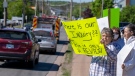 Family and friends of the victims protest outside the hotel where the Mass Casualty Commission inquiry into the mass murders in rural Nova Scotia on April 18/19, 2020, is being held in Truro, N.S. on Thursday, May 26, 2022. (THE CANADIAN PRESS/Andrew Vaughan)