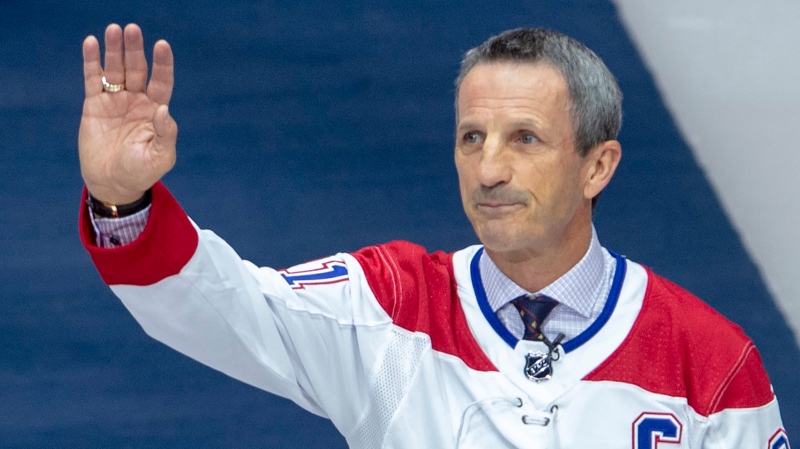 Former Montreal Canadien Guy Carbonneau waves to fans as he gets a standing ovation for his induction into the Hockey Hall of Fame during pre-game ceremonies in Montreal, Wednesday, Nov. 20, 2019. THE CANADIAN PRESS/Ryan Remiorz