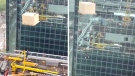 Construction worker dangles from crane in Toronto