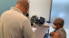 Ontario Pharmacists Association chairman and owner of Bradys Drugstore, Tim Brady administers a COVID-19 booster shot in Essex, Ont., on Wednesday July 6, 2022. (Chris Campbell/CTV News Windsor)