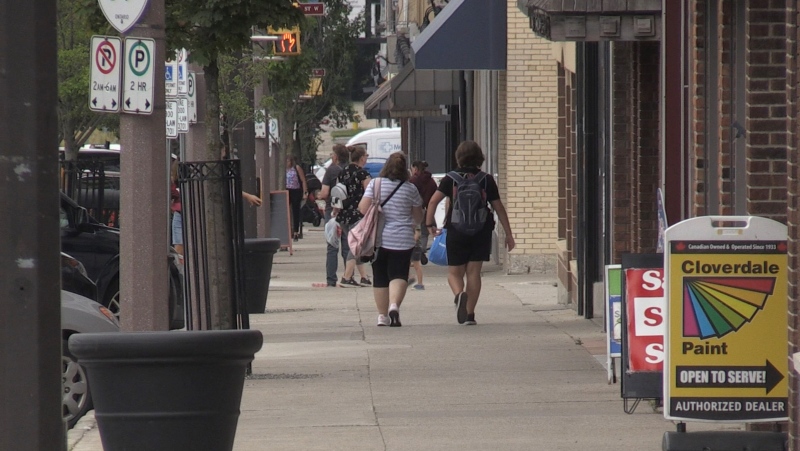 People walk down the street in Tillsonburg, Ont. on July 6, 2022. (Bryan Bicknell/CTV News London)
