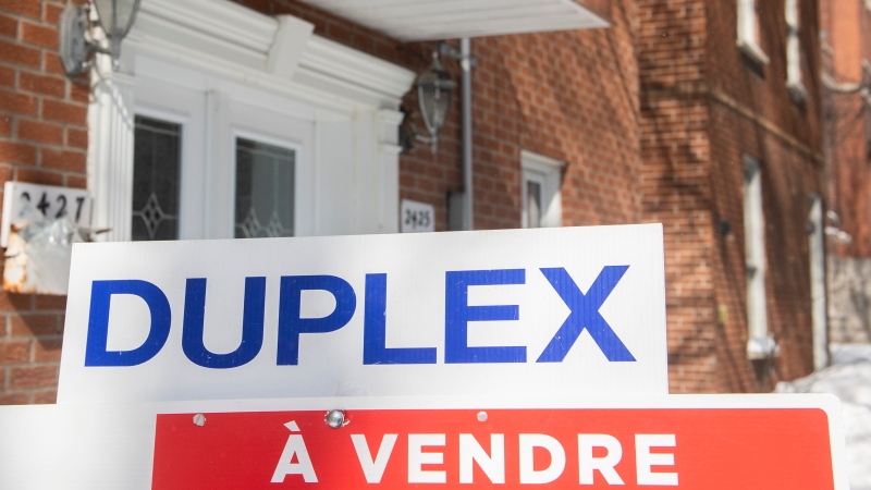 A sign advertising the sale of a duplex is shown in Montreal, Friday, March 4, 2022. THE CANADIAN PRESS/Graham Hughes