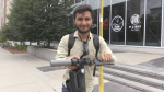 Yagnik Joshi stands with his e-scooter in Waterloo. (Carmen Wong/CTV Kitchener)