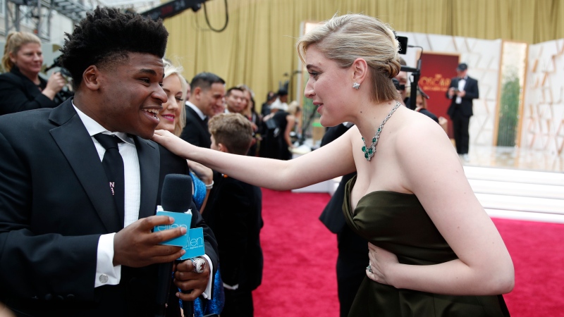 Greta Gerwig, right, talks to Jerry Harris on the red carpet at the Oscars at the Dolby Theatre in Los Angeles, Feb. 9, 2020. (AP Photo/John Locher File)