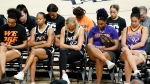 Phoenix Mercury players bow their heads in prayer at a rally for WNBA teammate Brittney Griner, July 6, 2022, in Phoenix. (AP Photo/Ross D. Franklin)