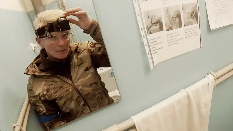 Yuliia Paievska, known as Taira, looks in the mirror and turns off her camera in Mariupol, Ukraine, Feb. 27, 2022. (Yuliia Paievska via AP)