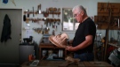 First Nations artist Richard Hunt began carving at the age of 13. Now at 71, he continues to hone his skills as he works on his latest piece, the Sun Mask, using red cedar to create his one of a kind artwork at his studio in Victoria, B.C., June 30, 2022 THE CANADIAN PRESS/Chad Hipolito
