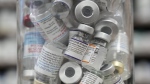 A jar full of empty COVID-19 vaccine vials is shown at the Junction Chemist pharmacy during the COVID-19 pandemic in Toronto, April 6, 2022. THE CANADIAN PRESS/Nathan Denette
