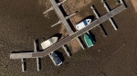 FILE - Pleasure boats tied to a pier rest on dry ground of the water depleted Zezere River due to drought, near Figueiro dos Vinhos in central Portugal, Feb. 17, 2022. (AP Photo/Sergio Azenha, File)
