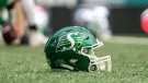 A football helmet sits on the field before CFL football action with the Hamilton Tiger-Cats playing the Saskatchewan Roughriders in Regina on Saturday, June 11, 2022. THE CANADIAN PRESS/Heywood Yu