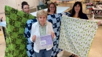 Employees of Great Pretenders in Point Edward, Ont. hold blankets for homeless people and pets being manufactured out of unused masking materials, July 11, 2022. (Sean Irvine/CTV News London)