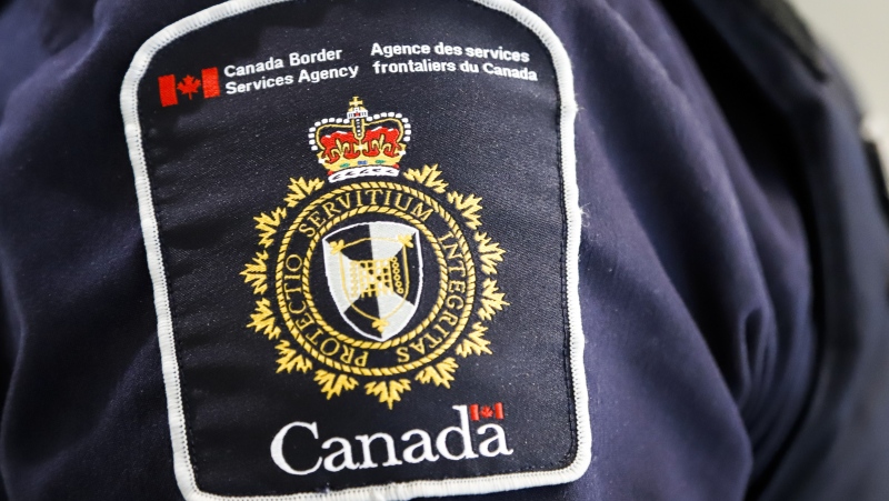 A Canada Border Services Agency (CBSA) patch is seen on an officer in Calgary on August 1, 2019. (THE CANADIAN PRESS/Jeff McIntosh)
