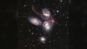 This image provided by NASA on Tuesday, July 12, 2022, shows Stephan's Quintet, a visual grouping of five galaxies captured by the Webb Telescope's Near-Infrared Camera (NIRCam) and Mid-Infrared Instrument (MIRI). (NASA, ESA, CSA, and STScI via AP)