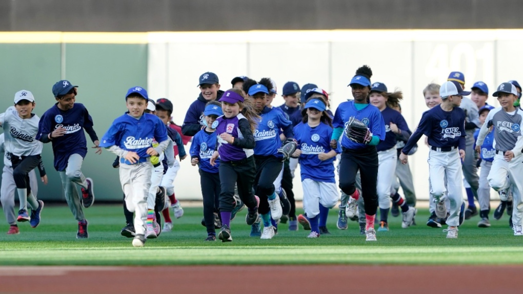 Little League players run on the field in Seattle