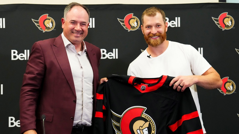 Ottawa Senators general manager Pierre Dorion gives Claude Giroux his Senators sweater in Ottawa on Wednesday, July 13, 2022, after signing a 3-year contract with veteran forward. (Sean Kilpatrick/THE CANADIAN PRESS)
