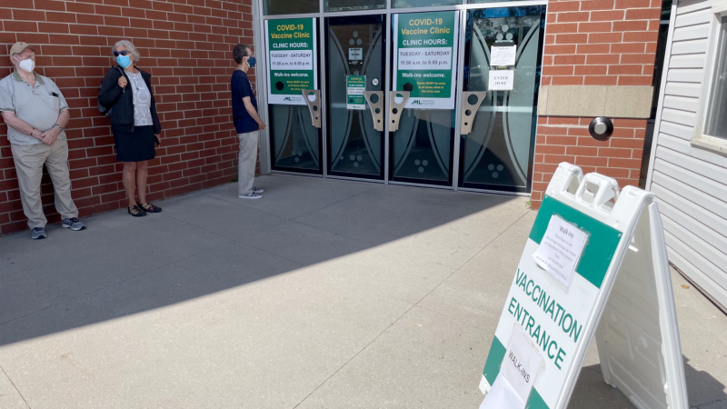 The front of a line, about 40 people deep, is seen just prior to the 11 a.m. opening of the Middlesex-London Health Unit Agriplex COVID-19 vaccination centre. July 14, 2022. (Sean Irvine/CTV News London)