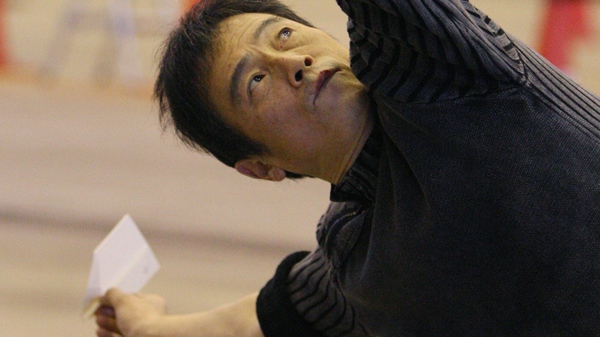 Japanese paper airplane virtuoso Takuo Toda prepares to release a paper airplane during a record attempt at a hangar near Haneda Airport in Tokyo, Japan, on Sunday, Dec. 27, 2009. (AP / Koji Sasahara)