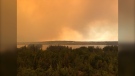 A fire burns near Pukatawagan, Manitoba shortly after 1 p.m. on July 14, 2022. An evacuation order was issued for the community (Photo courtesy Ralph Caribou).