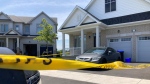 Yellow police tape surrounds a home in Wasaga Beach, Ont., on Fri., July 15, 2022, as police investigate a shooting. (CTV News/KC Colby)
