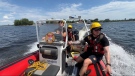 Ottawa firefighters from the water rescue unit travel along the Ottawa River as part of a victim rescue demonstration. Ottawa, Ont.. Jul. 20, 2022. (Tyler Fleming/CTV News Ottawa) 