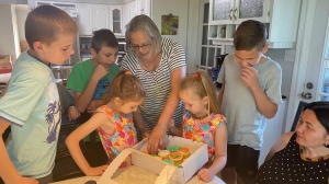 Cathy Locke (C) is surrounded by her house guests, a Ukrainian family seeking refuge in Barrie, Ont. (CTV News/Ian Duffy)