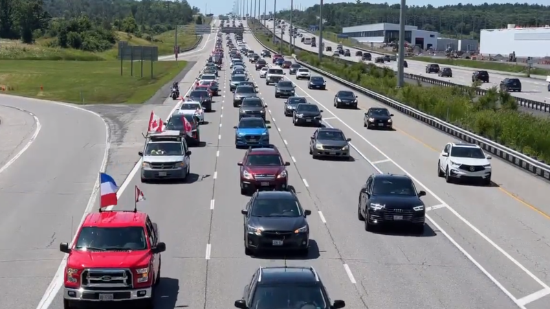 Dozens of vehicles, waving Canadian and Dutch flags, roll into Ottawa as part of a demonstration to support Dutch farmers, who are protesting new government environmental regulations. (Jeremie Charron/CTV News Ottawa)