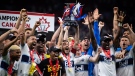 Vancouver Whitecaps' Russell Teibert, centre, hoists the Voyageurs Cup after Vancouver defeated Toronto FC in penalty kicks during the Canadian Championship soccer final, in Vancouver, on Tuesday, July 26, 2022. THE CANADIAN PRESS/Darryl Dyck