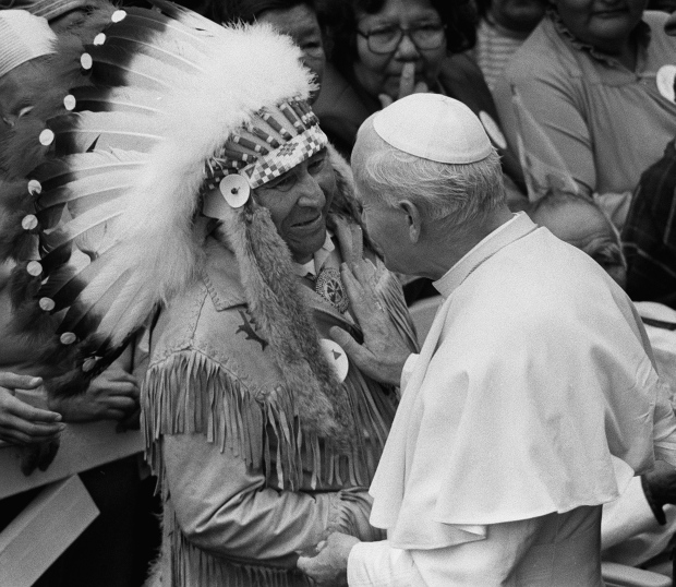Pope John Paul II lays his hand on an Indigenous chief during a visit on September 10, 1984. The Pope walked through the crowd greeting mainly Indigenous people, then boarded a train for three more stops, the last being Montreal. (CP PHOTO/Andy Clark)
