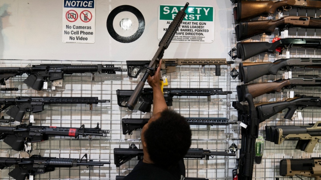 Salesperson grabs an AR-15-style rifle