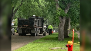 Winnipeg police remain at the scene of a  crash involving a dump truck and a pedestrian on July 27, 2022.