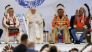 Surrounded by Grand Chiefs, Pope Francis reads his statement of apology during a visit with Indigenous peoples at Maskwaci, the former Ermineskin Residential School, Monday, July 25, 2022, in Maskwacis, Alberta. Pope Francis traveled to Canada to apologize to Indigenous peoples for the abuses committed by Catholic missionaries in the country's notorious residential schools. (AP Photo/Eric Gay)